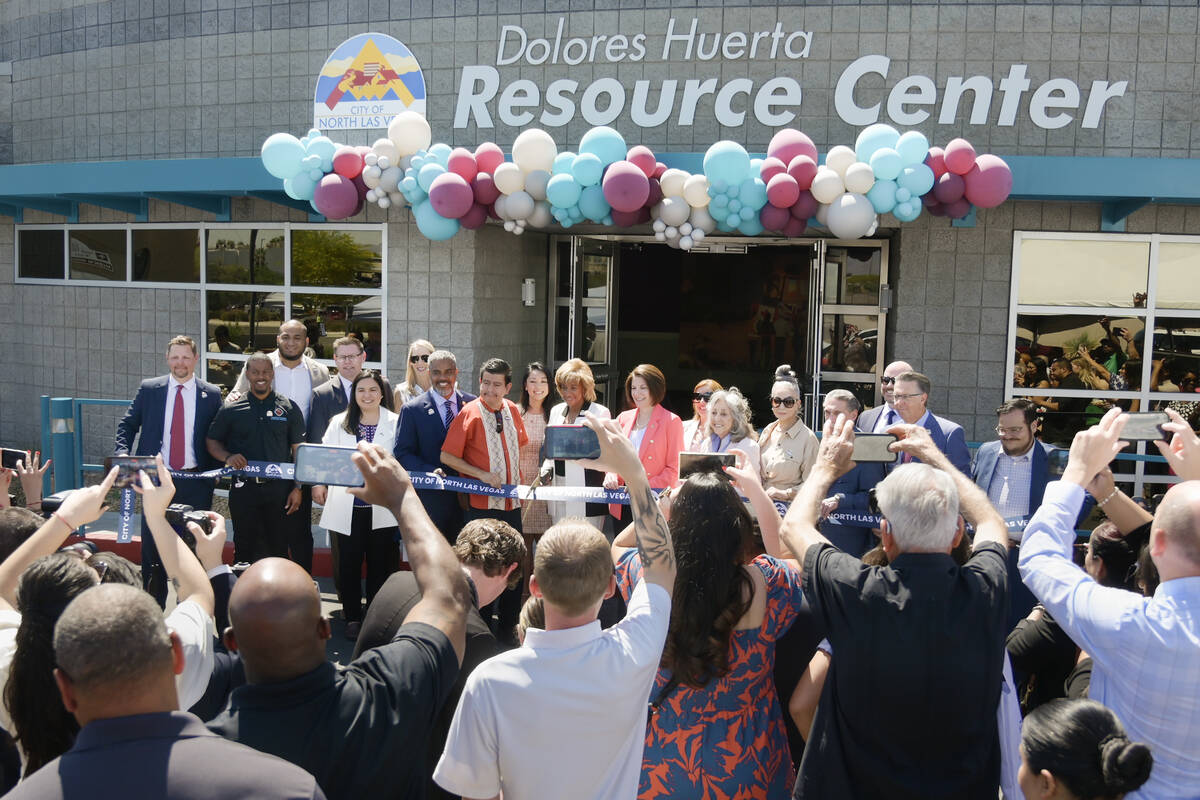Politicians and guests prepare to cut a ribbon during the grand opening of the Dolores Huerta R ...