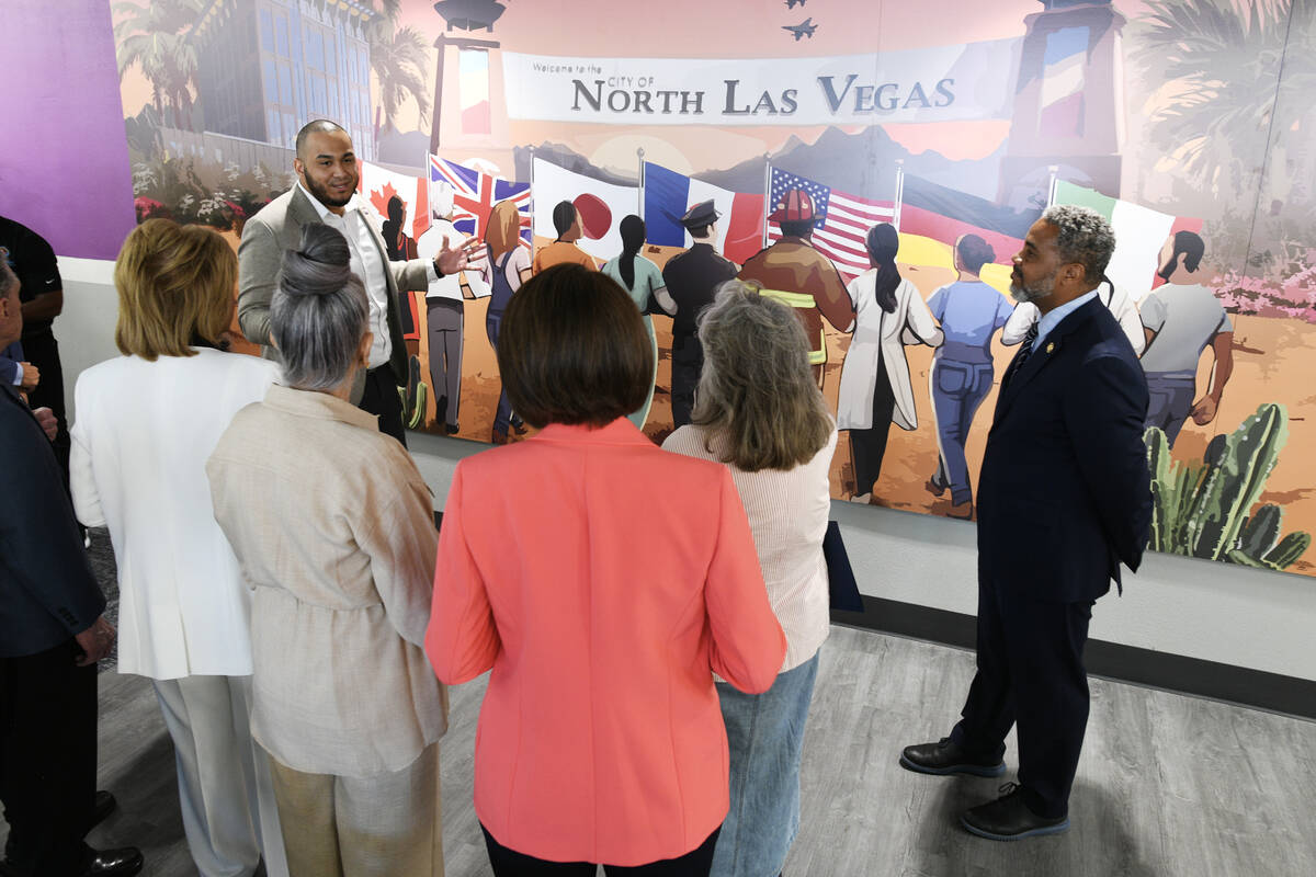 Wilson Ramos describes a mural to politicians and visitors during the grand opening of the Dolo ...