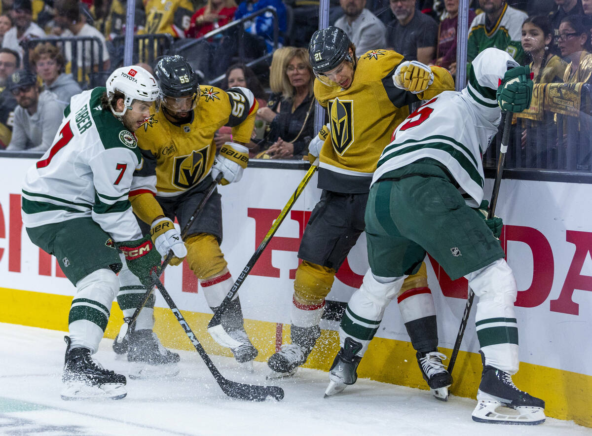Minnesota Wild defenseman Brock Faber (7) with Golden Knights right wing Keegan Kolesar (55) ba ...