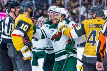 Golden Knights center Nicolas Roy (10) and Minnesota Wild center Frederick Gaudreau (89) tangle ...