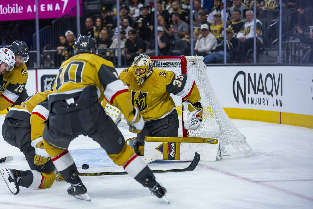 Golden Knights goaltender Adin Hill (33) deflects a shot by the Minnesota Wild during the secon ...