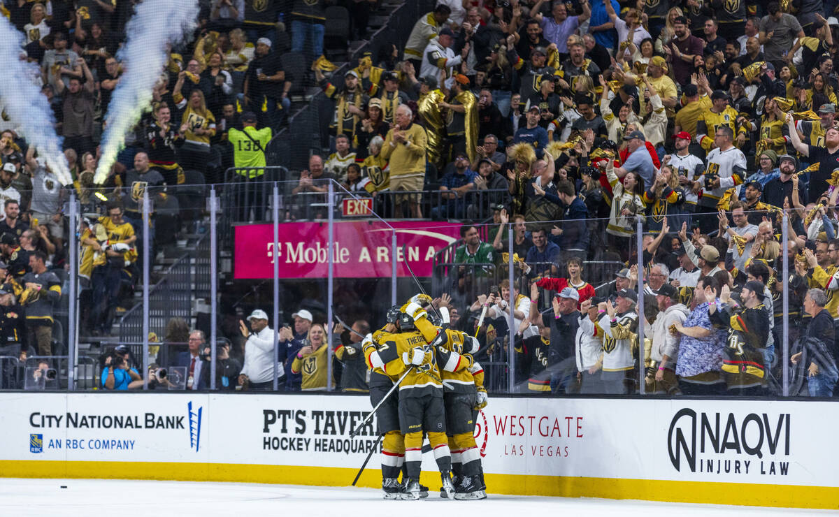 Golden Knights players celebrate their first goal against Minnesota Wild goaltender Filip Gusta ...