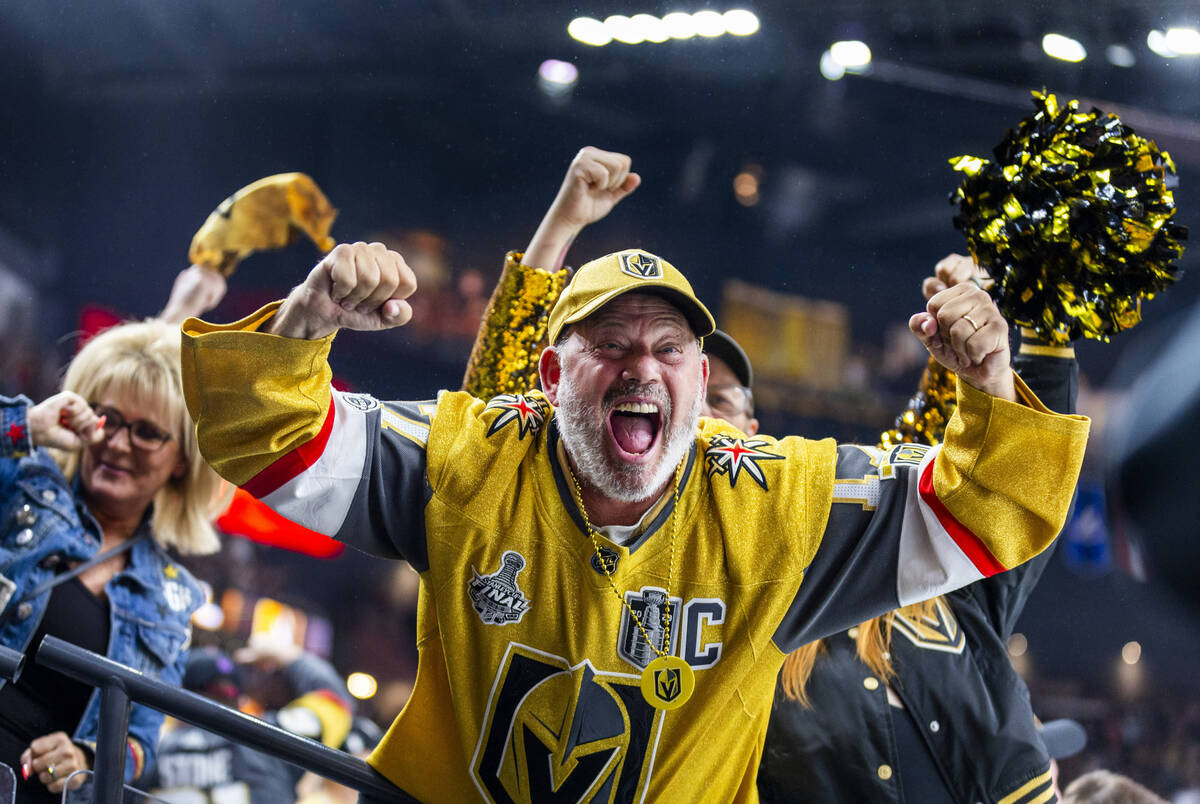 Golden Knights fans celebrate their first goal against Minnesota Wild goaltender Filip Gustavss ...