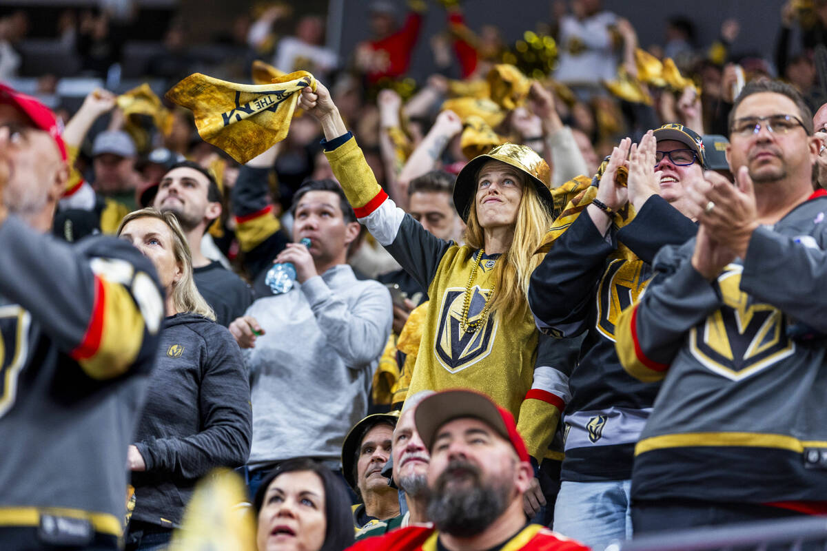 Golden Knights fans celebrate their first goal against Minnesota Wild goaltender Filip Gustavss ...