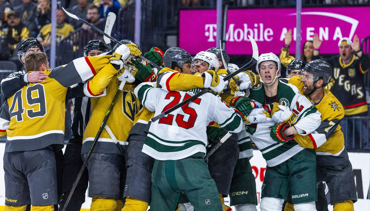 Golden Knights and Minnesota Wild players fight during the third period of game two in their St ...