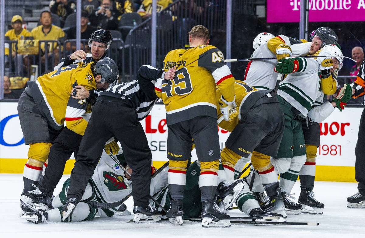 Golden Knights and Minnesota Wild players fight during the third period of game two in their St ...