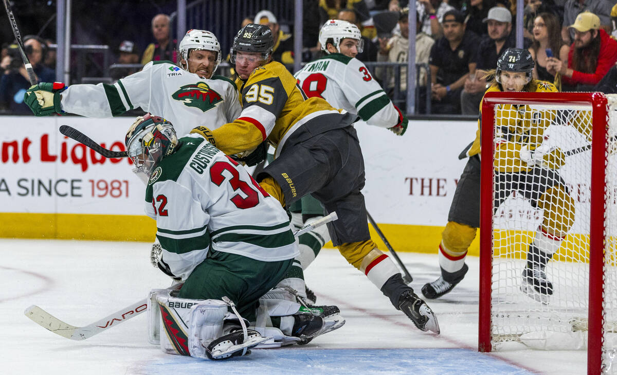 Minnesota Wild defenseman Jonas Brodin (25) is taken down to the ice by Golden Knights right wi ...