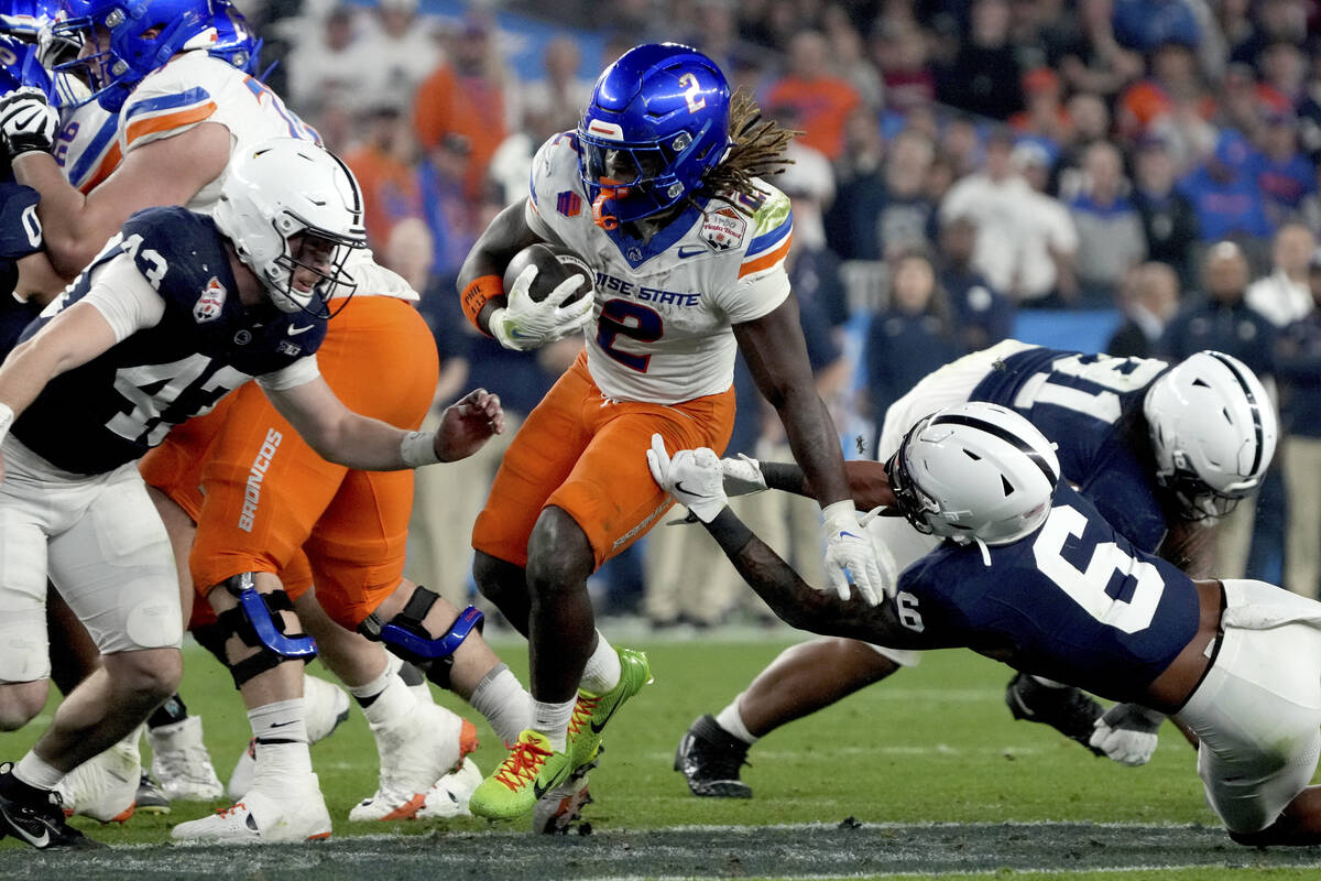 Boise State running back Ashton Jeanty (2) eludes the reach of Penn State safety Zakee Wheatley ...
