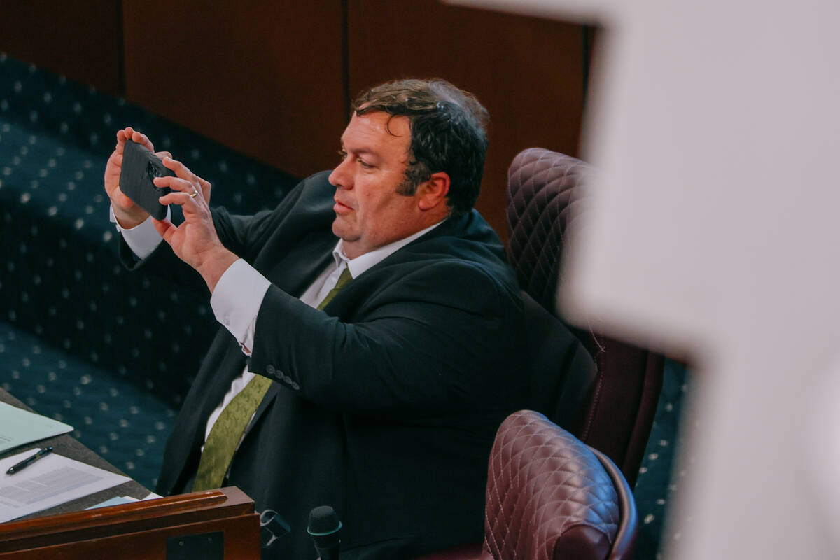 Senator James Ohrenschall, D-Las Vegas, takes a photo of the voting results for his bill, SB171 ...