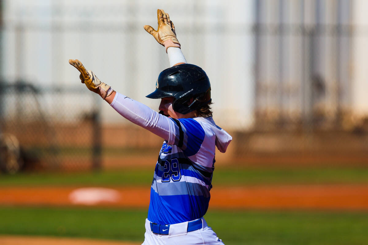 Basic third baseman Gabe McDowell celebrates getting to first base during a high school basebal ...