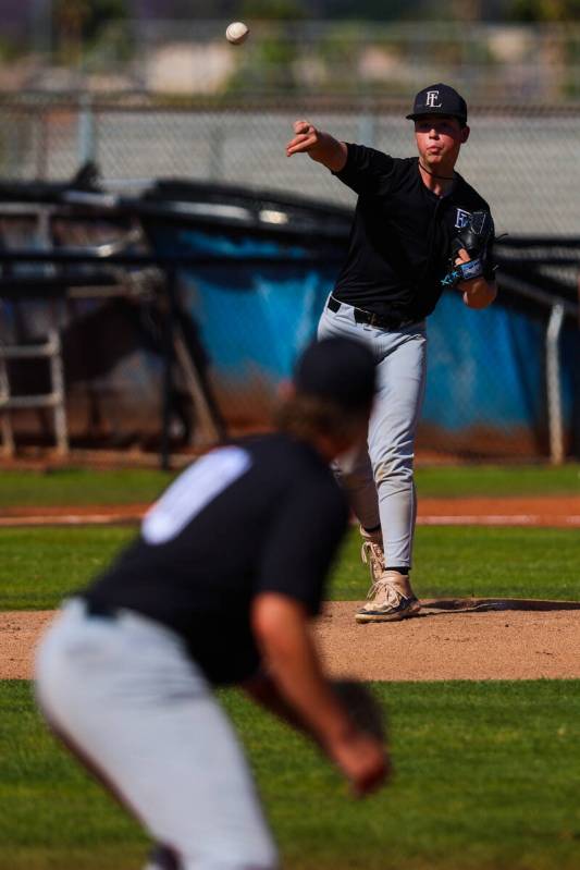 Faith Lutheran pitcher Cash Martin throws the ball to a teammate to hold the runner during a hi ...