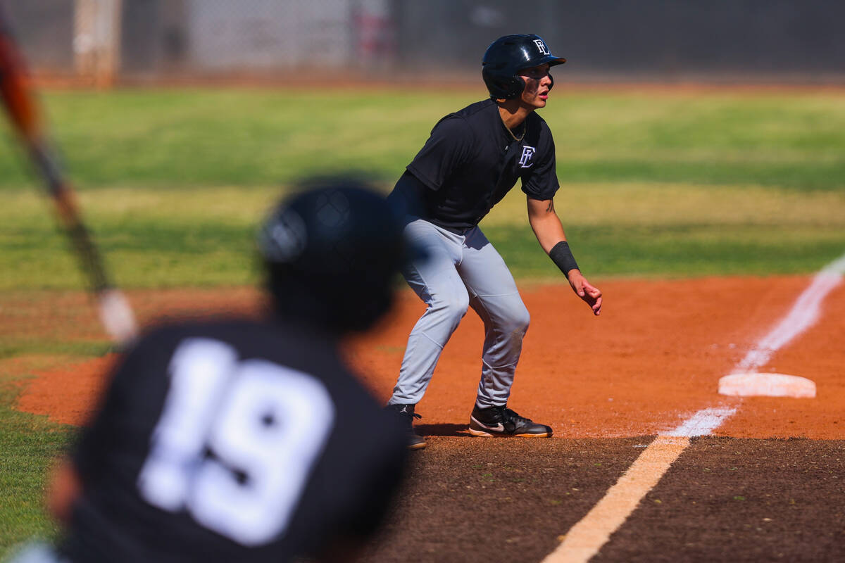 Faith Lutheran infielder Kingston Kela (2) watches for his chance to run to home base during a ...