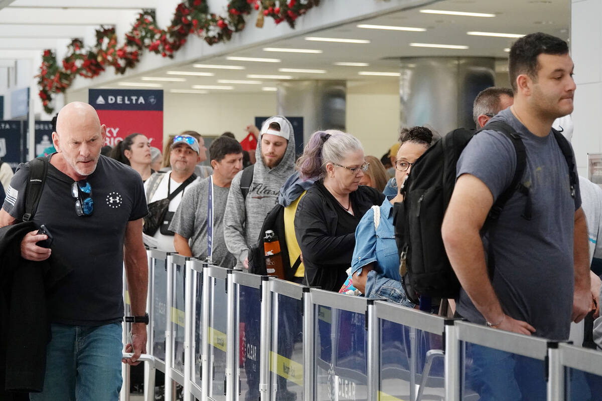 Passengers wait in line to pass through the TSA checkpoint at Fort Lauderdale-Hollywood Interna ...