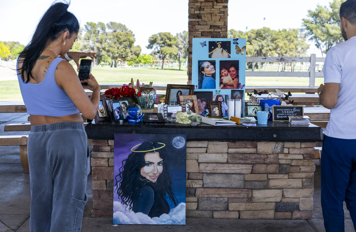 A woman takes a photo during Tabatha Tozzi’s celebration of life at Craig Ranch Regional Park ...