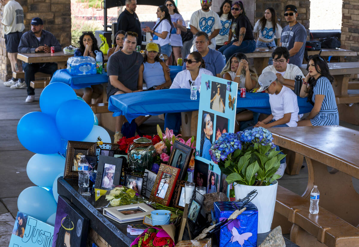 Family and friends listen in as Regina Lacerda talks to the media about her daughter Tabatha To ...