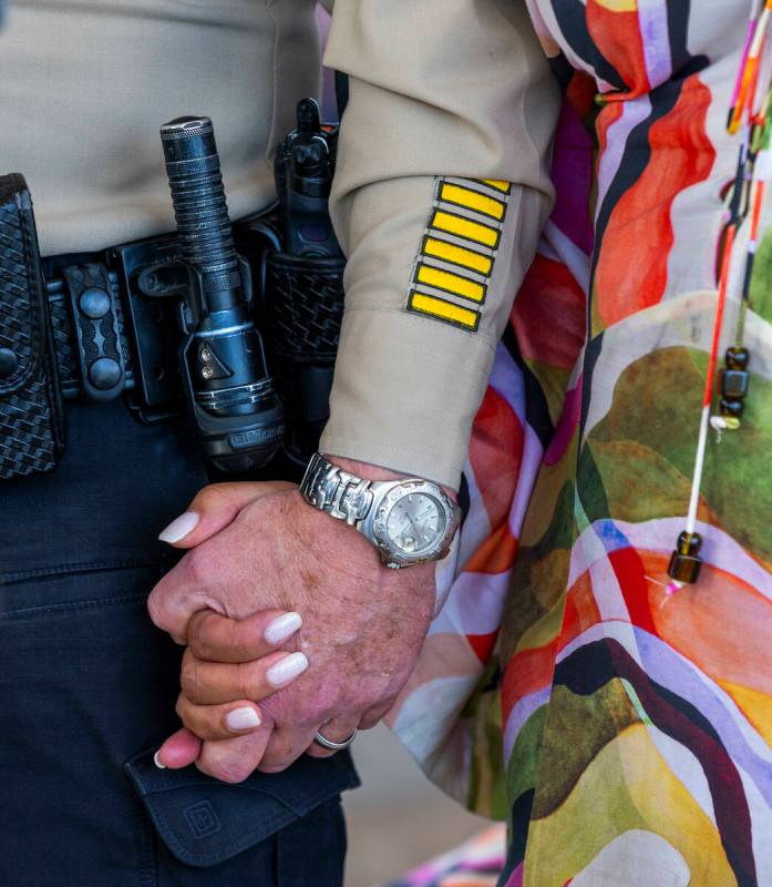 Las Vegas Metropolitan Police Department Undersheriff Andrew Walsh holds hands with Regina Lace ...