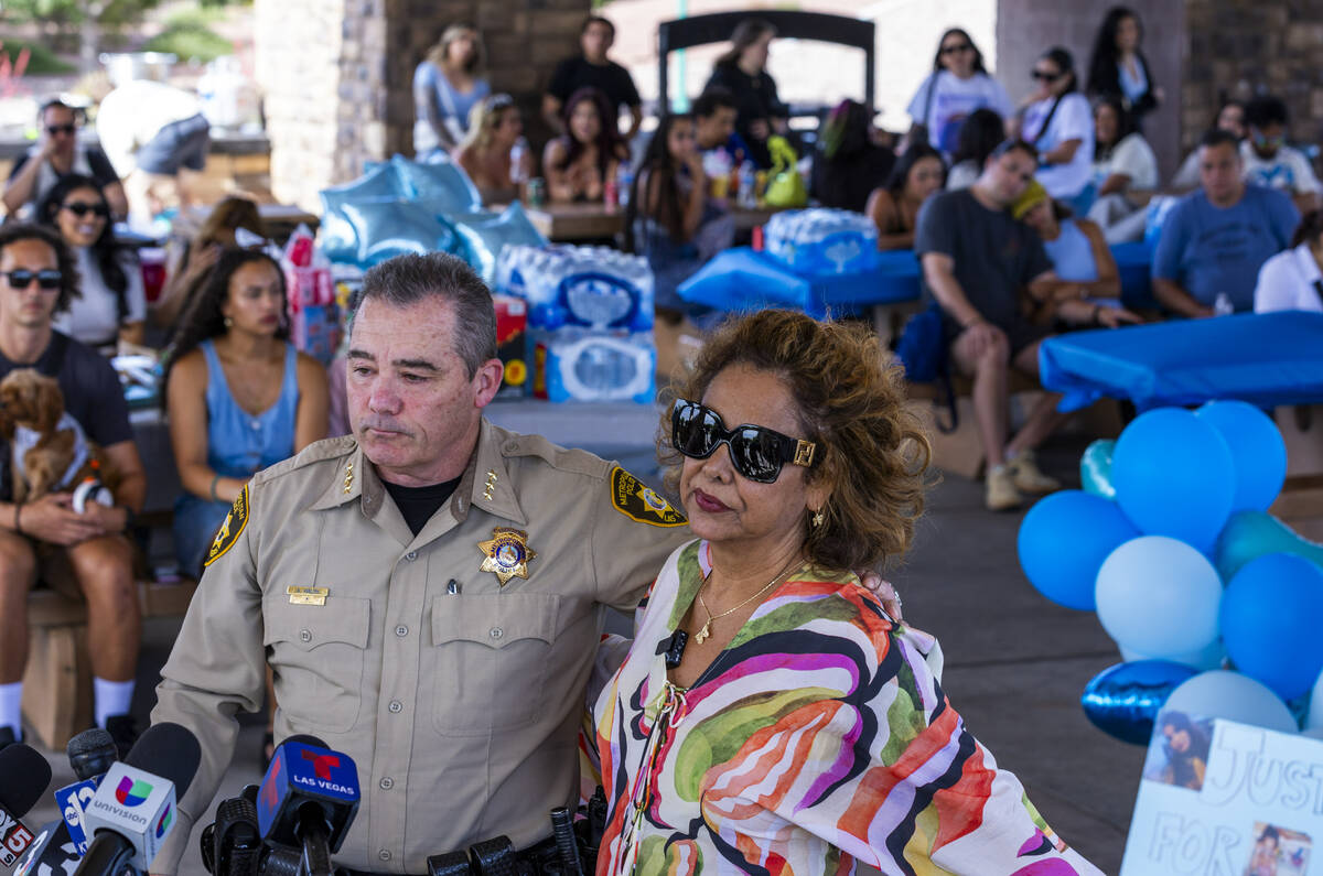Las Vegas Metropolitan Police Department Undersheriff Andrew Walsh stands with Regina Lacerda a ...
