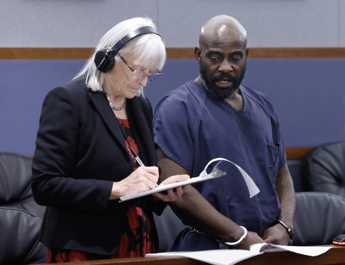 An Spanish interpreter takes notes as Guillermo Senobua, right, who pleaded guilty to driving u ...