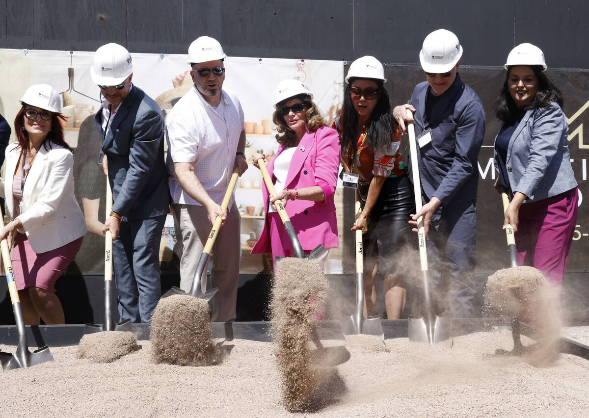Mayor Shelley Berkley, center, Weina Zhang, founder and CEO of Midtown Las Vegas, third right, ...