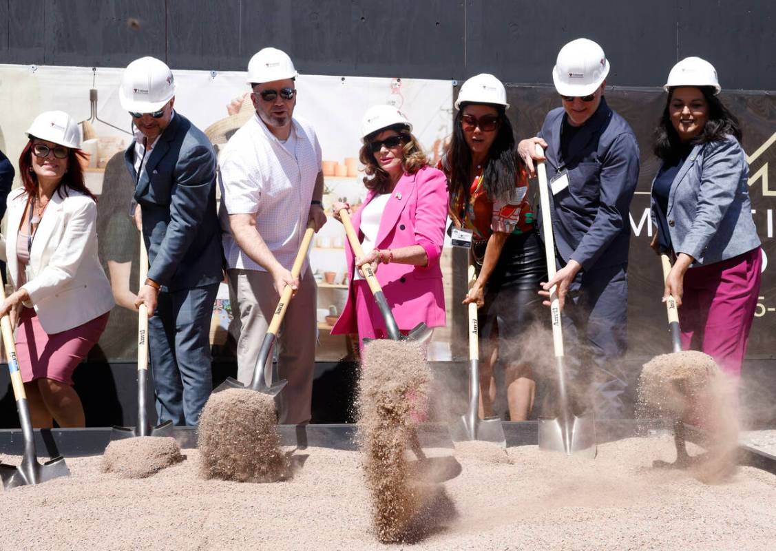 Mayor Shelley Berkley, center, Weina Zhang, founder and CEO of Midtown Las Vegas, third right, ...