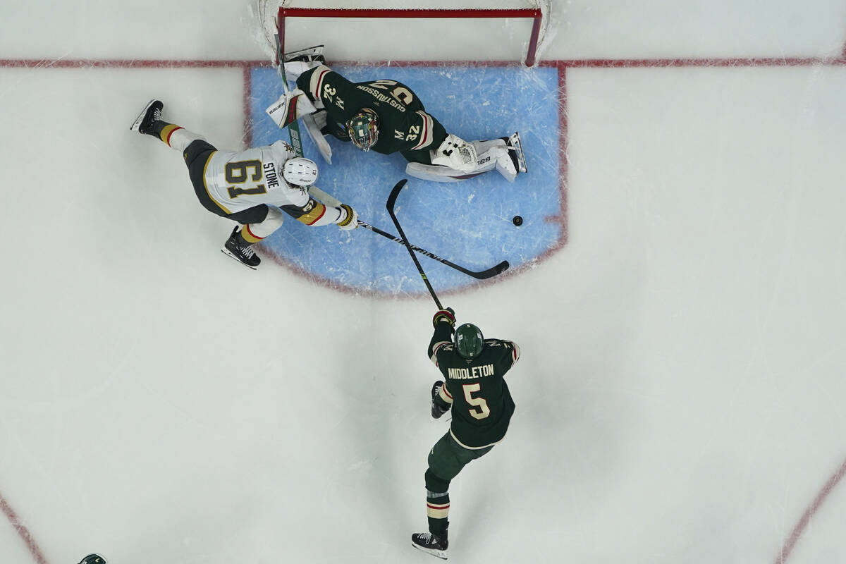 Minnesota Wild goaltender Filip Gustavsson (32) and defenseman Jake Middleton (5) defend agains ...