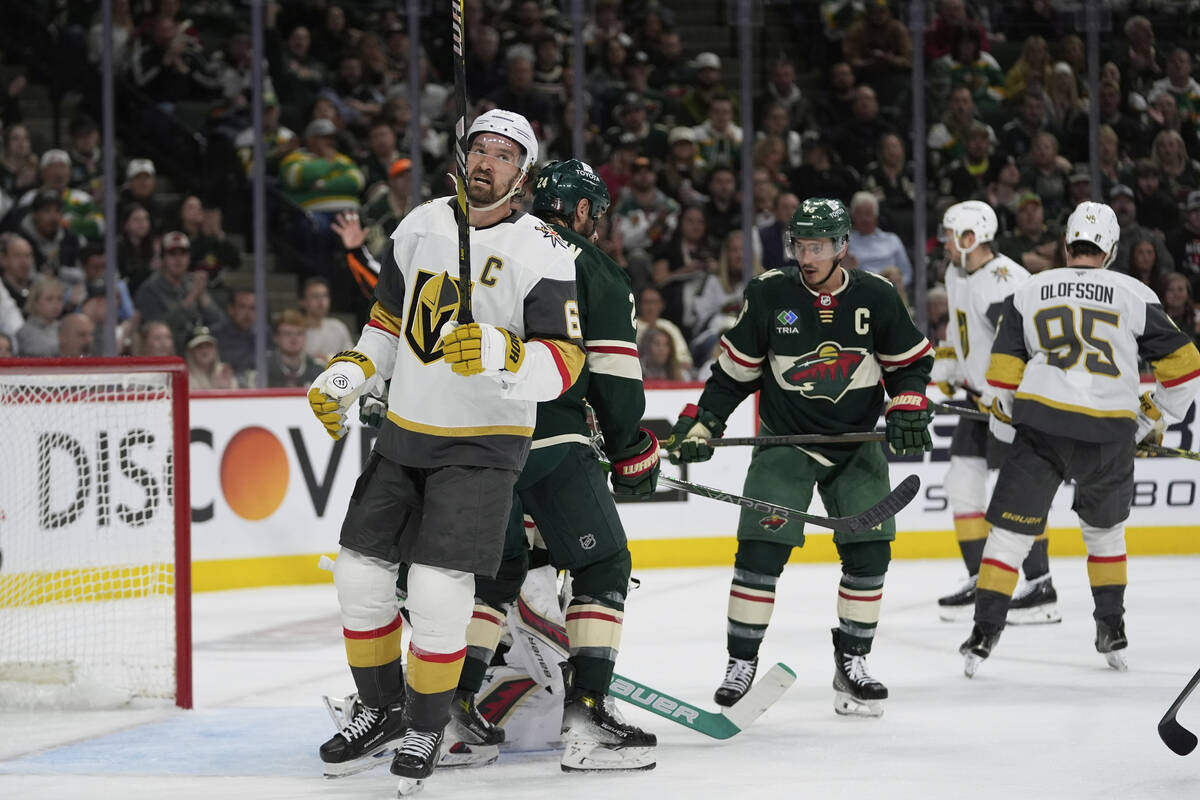 Vegas Golden Knights right wing Mark Stone, left, stands on the ice after a stop by Minnesota W ...