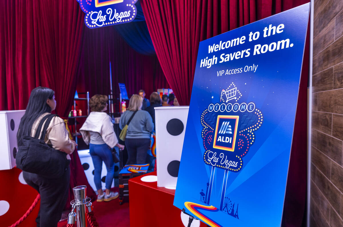Customers enter the "high savers room" as Aldi is officially open on Thursday, April ...