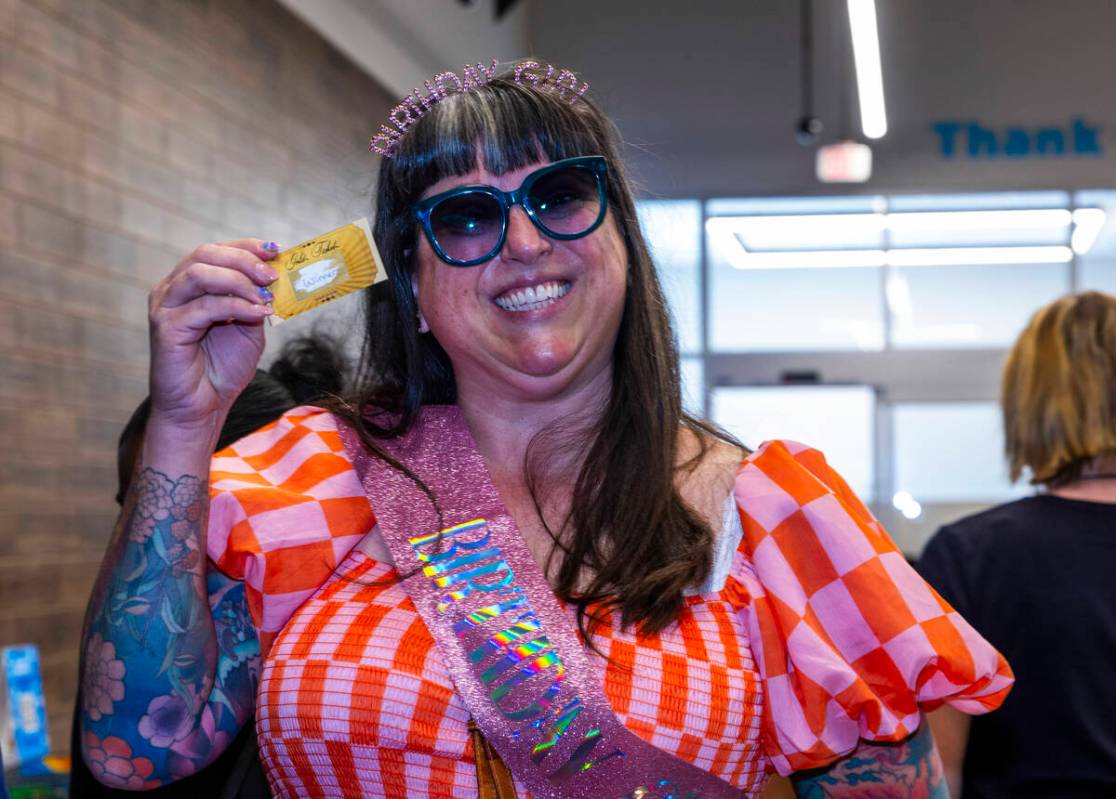 Birthday girl Sarah Angelo holds a winning scratch-off ticket to use within the "high save ...