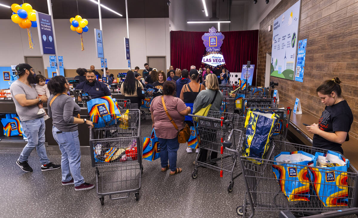 Customers exit while others seek to enter the "high savers room" as Aldi is officiall ...