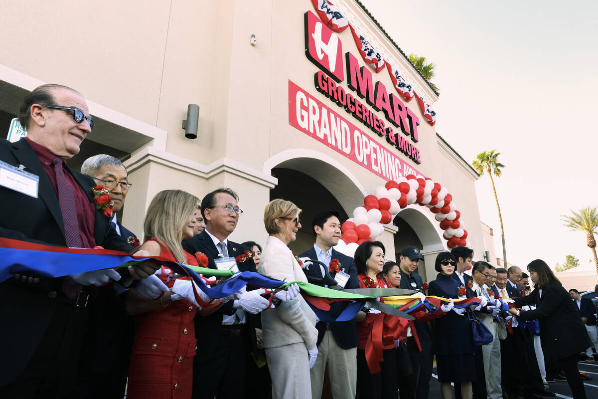 H Mart President Brian Kwon, center, is joined by Rep. Susie Lee, D-Nev, left, as they prepare ...