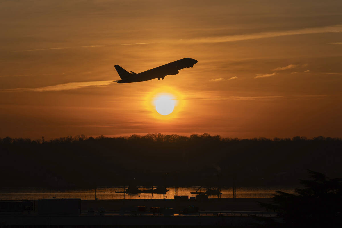 An airplane lifts off from Ronald Reagan Washington National Airport as the sun rises Monday, F ...