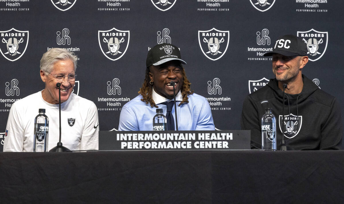 Raiders running back Ashton Jeanty, center, laughs as head coach Pete Carroll, left, and John S ...
