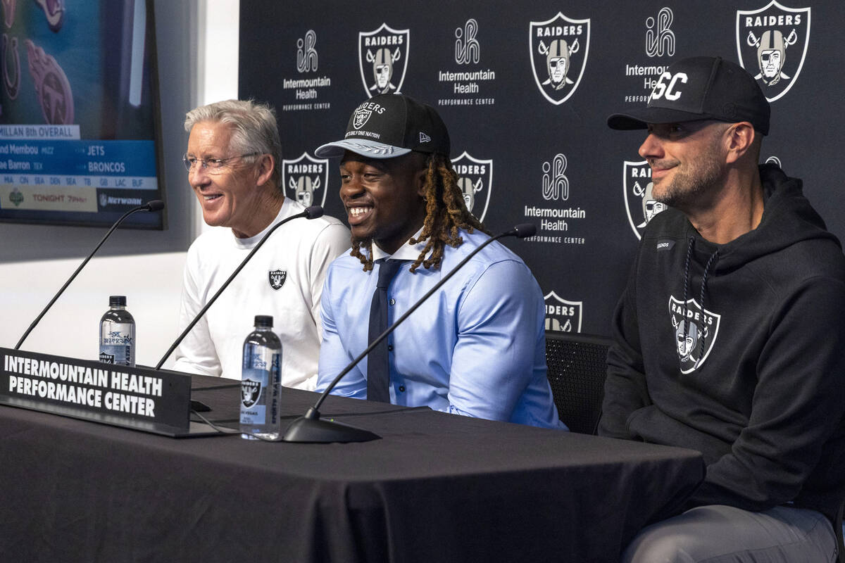 Raiders running back Ashton Jeanty, center, reacts to a question asked by media as he is introd ...