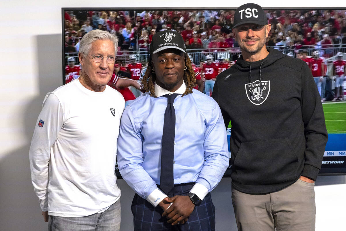 Raiders head coach Pete Carroll, left, running back Ashton Jeanty, center, and general manager ...