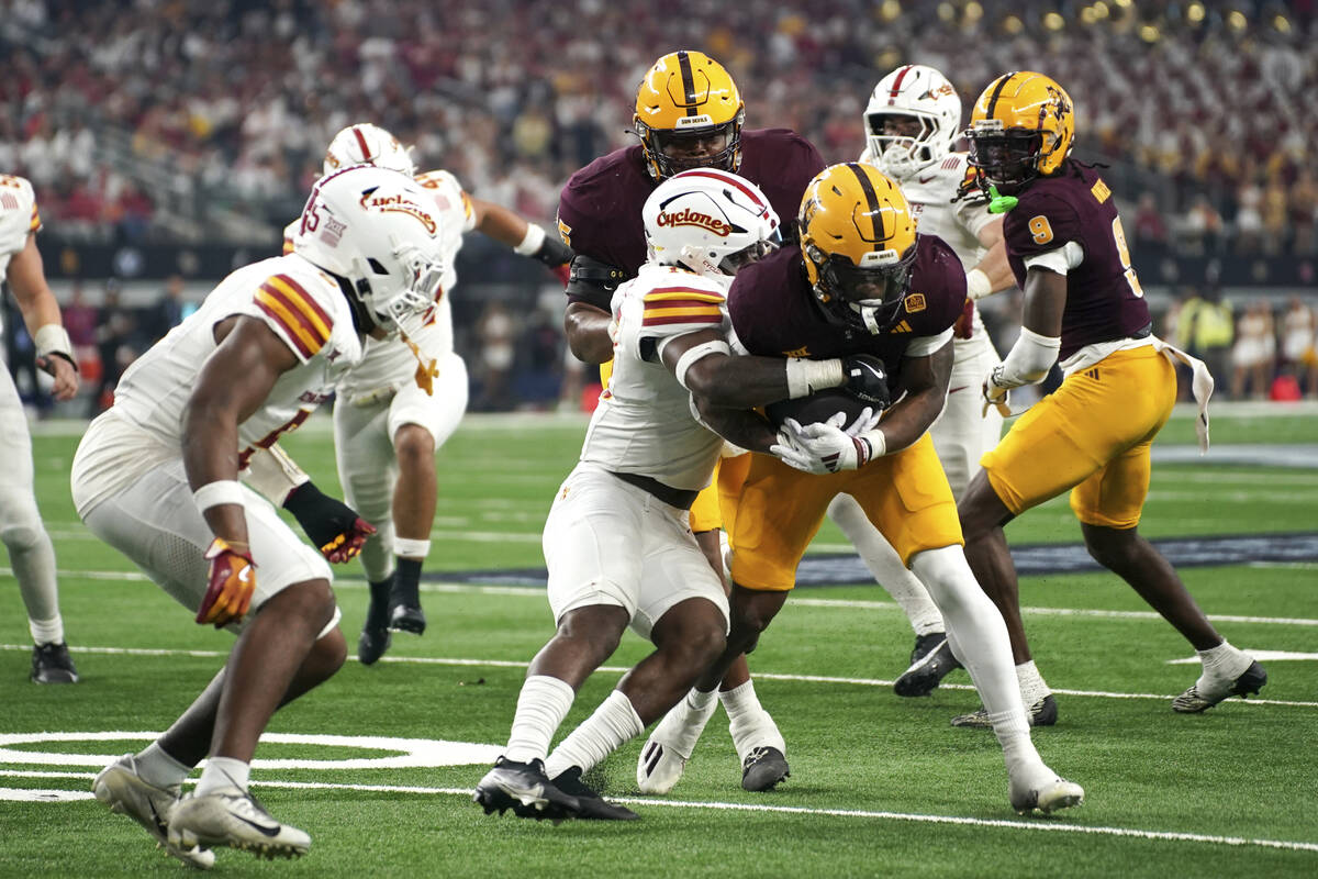 Arizona State running back Kyson Brown (2) gets tackled by Iowa State defensive back Darien Por ...