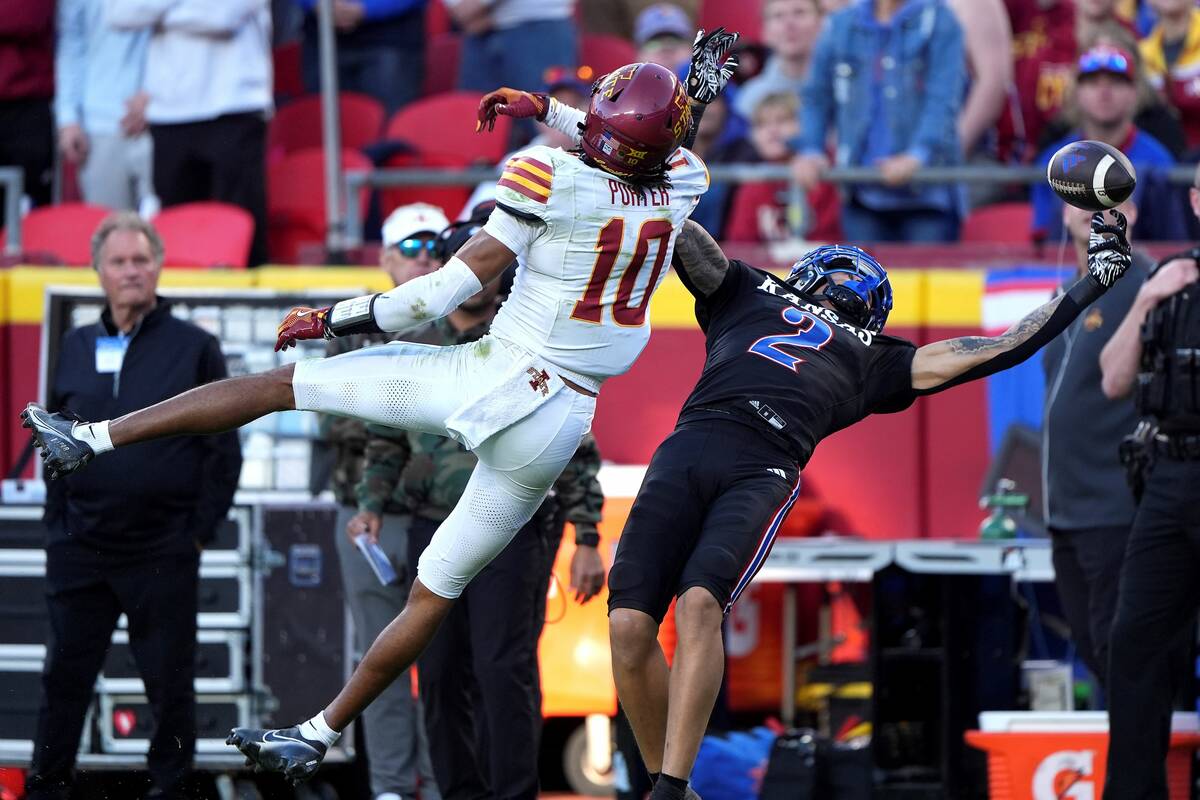 Iowa State defensive back Darien Porter (10) breaks up a pass intended for Kansas wide receiver ...
