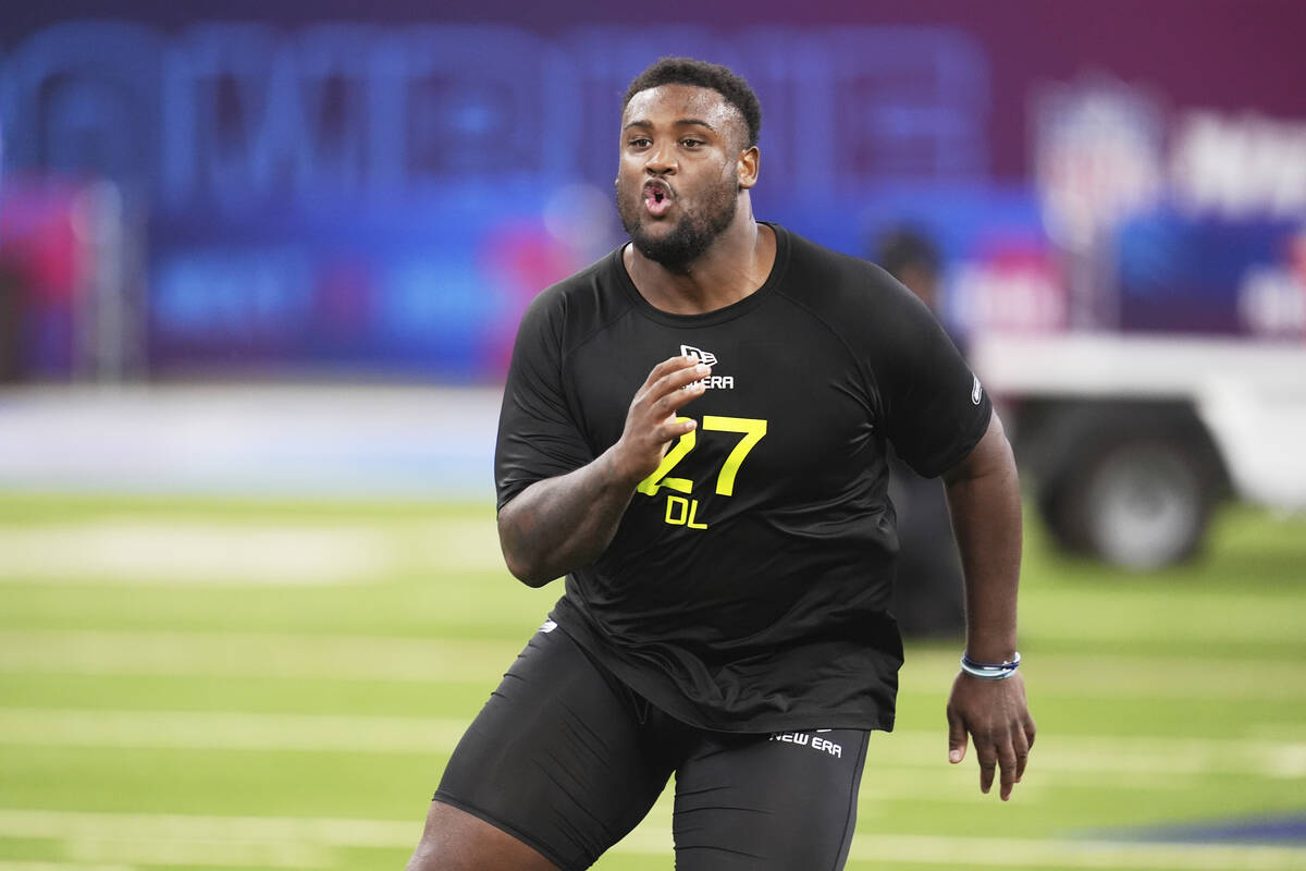 Mississippi defensive lineman JJ Pegues runs a drill at the NFL football scouting combine in In ...