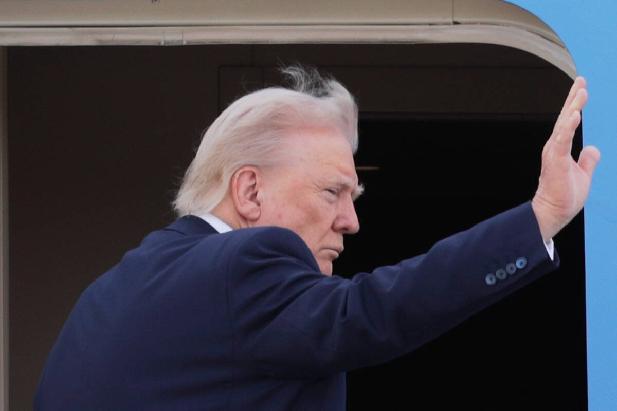 President Donald Trump waves from the stairs of Air Force One, upon his arrival at Joint Base A ...
