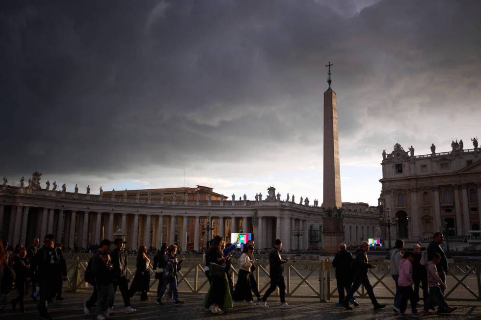 People walk to enter St. Peter's Basilica to pay their respects to Pope Francis lying in state, ...