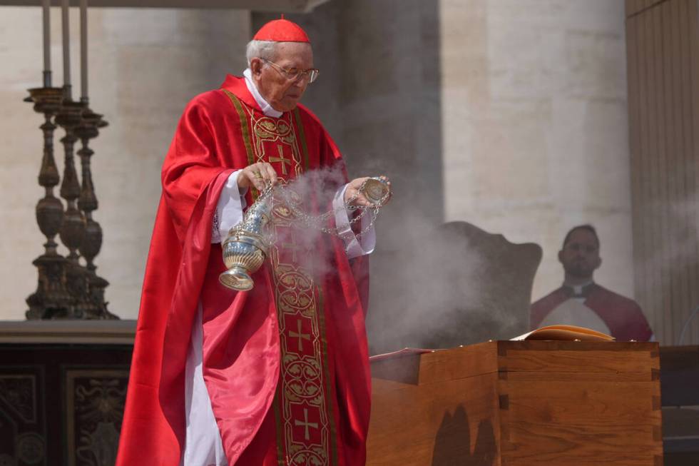 Dean of the College of Cardinals Giovanni Battista Re blesses the coffin during the funeral of ...