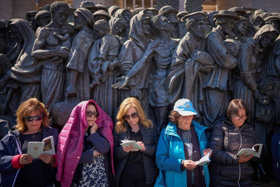 Faithful listen to mass during the funeral of Pope Francis in St. Peter's Square at the Vatican ...