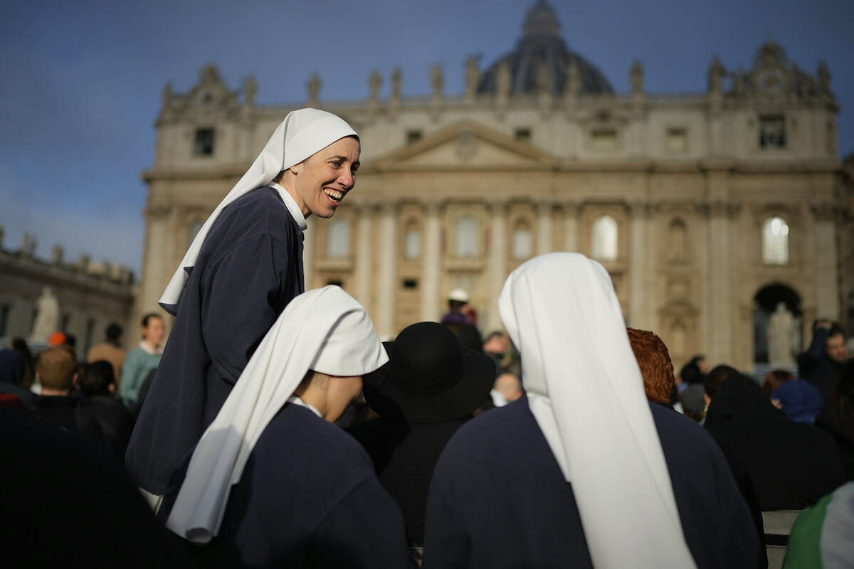 Nuns share a laugh as people gather for the funeral of Pope Francis in St. Peter's Square at th ...