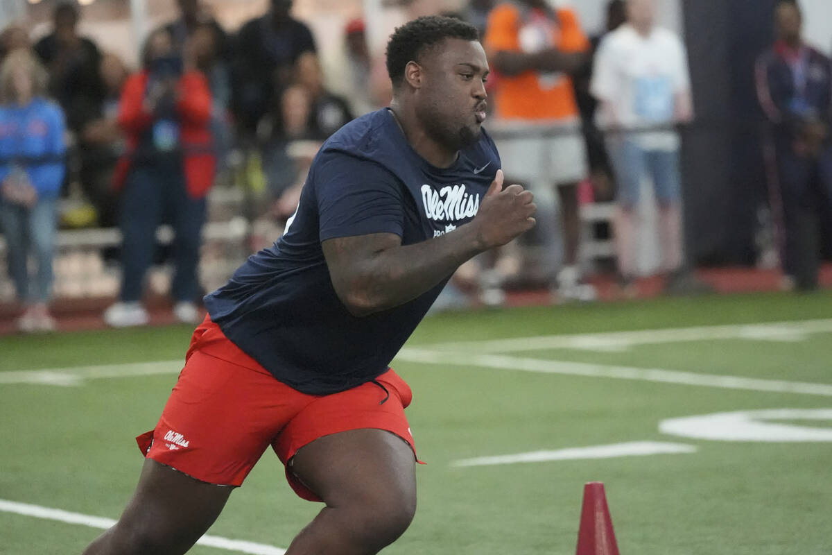 Mississippi defensive tackle JJ Pegues sprints toward the finish line during an offensive drill ...