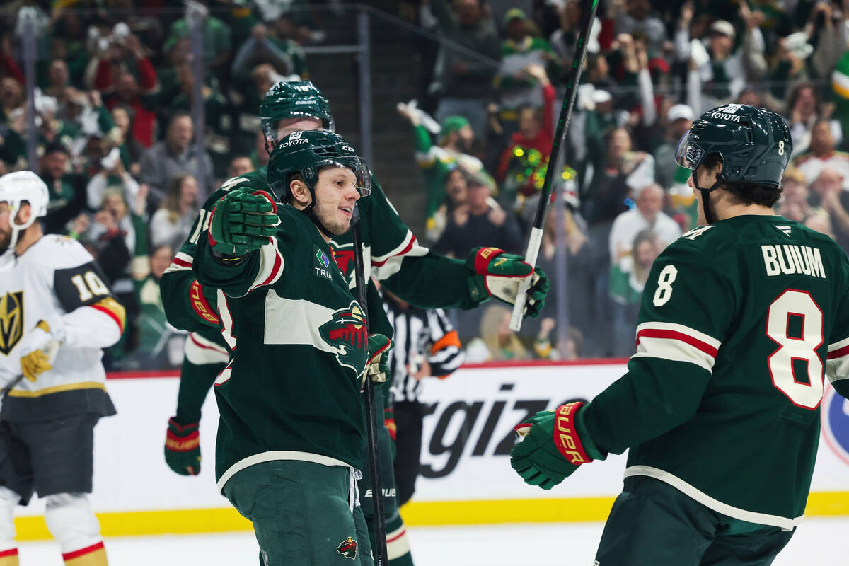 Minnesota Wild center Marco Rossi (23) is greeted by defenseman Zeev Buium (8) after scoring a ...