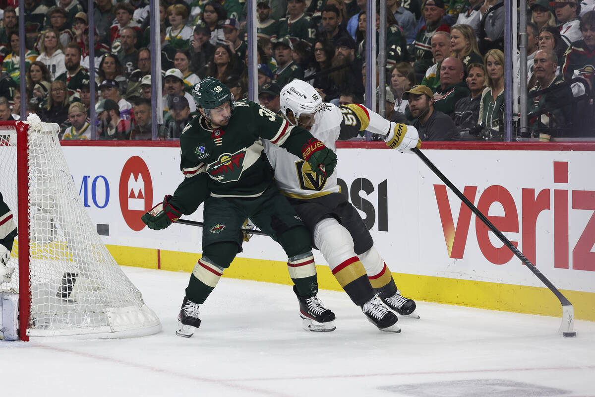 Vegas Golden Knights right wing Keegan Kolesar (55) holds Minnesota Wild right wing Mats Zuccar ...