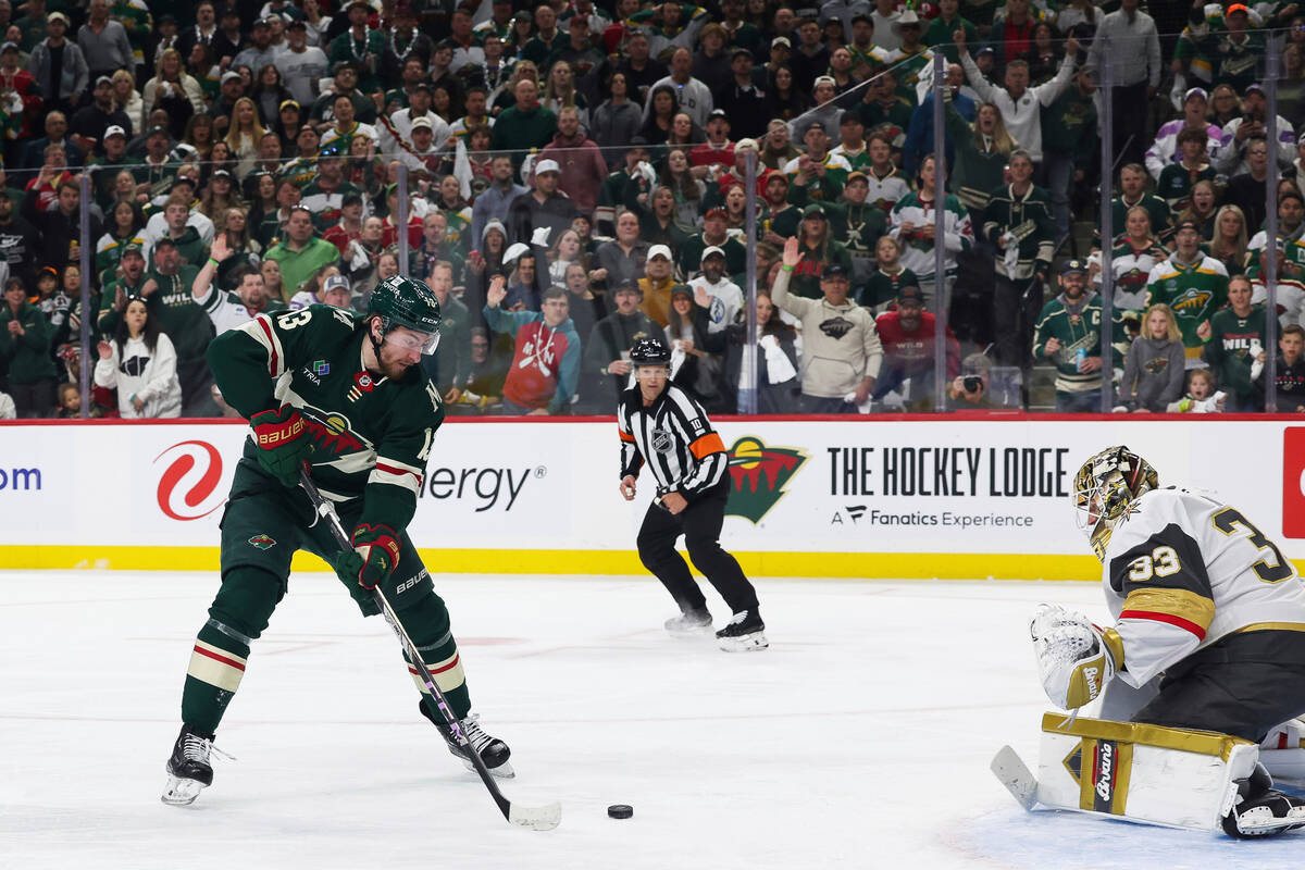 Minnesota Wild center Yakov Trenin (13) controls the puck in front of the net against Vegas Gol ...