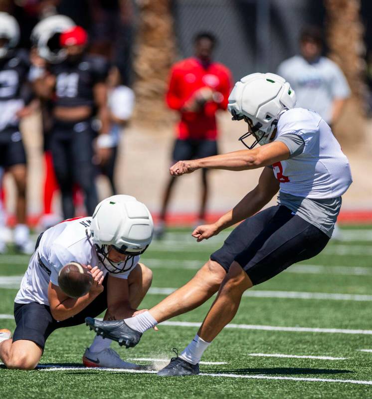 Kicker Ramon Villela (3) attempts an extra point held by punter Cameron Brown (0) during UNLV s ...