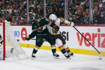 Vegas Golden Knights right wing Keegan Kolesar (55) holds Minnesota Wild right wing Mats Zuccar ...
