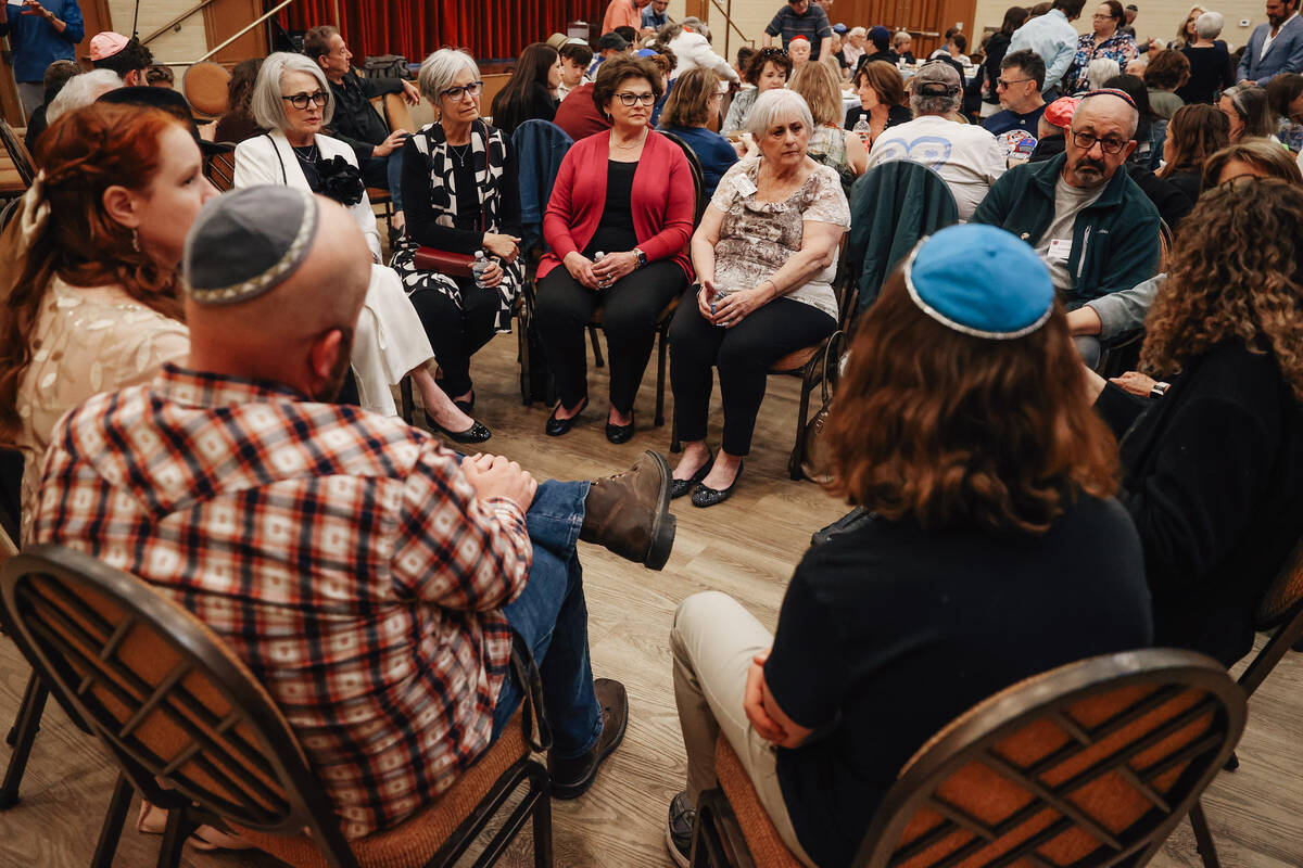 People listen to stories from holocaust survivors during a Yom HaShoah community remembrance at ...