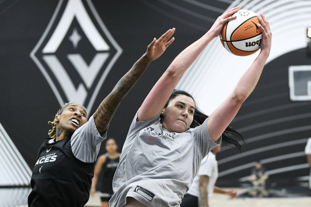Crystal Bradford, left, and Megan Gustafson reach for a rebound during the Las Vegas Aces first ...